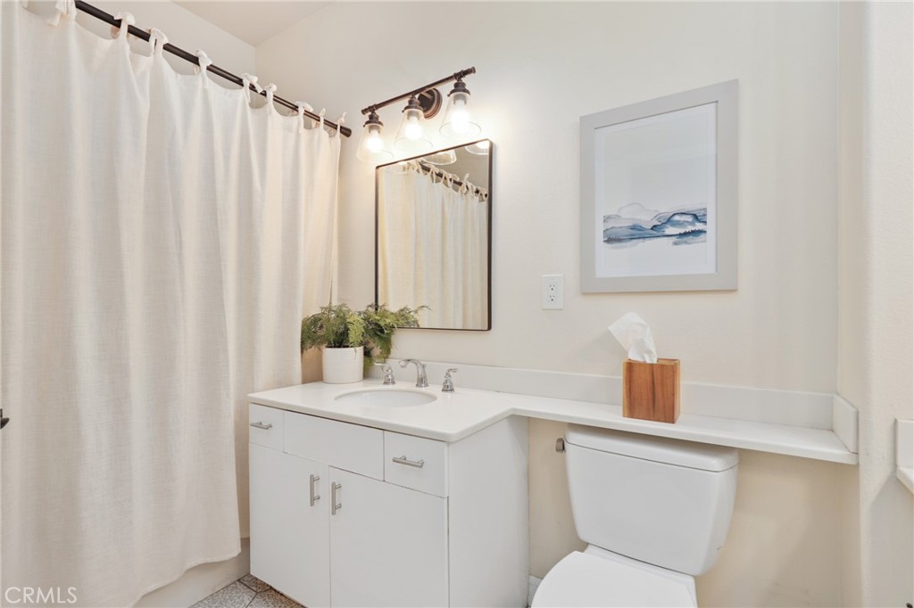 12 Montana Del Lago Drive, Unit 168 Rancho Santa Margarita, CA 92688 - Photo 15 of 23 a bathroom with a sink a toilet and shower curtain