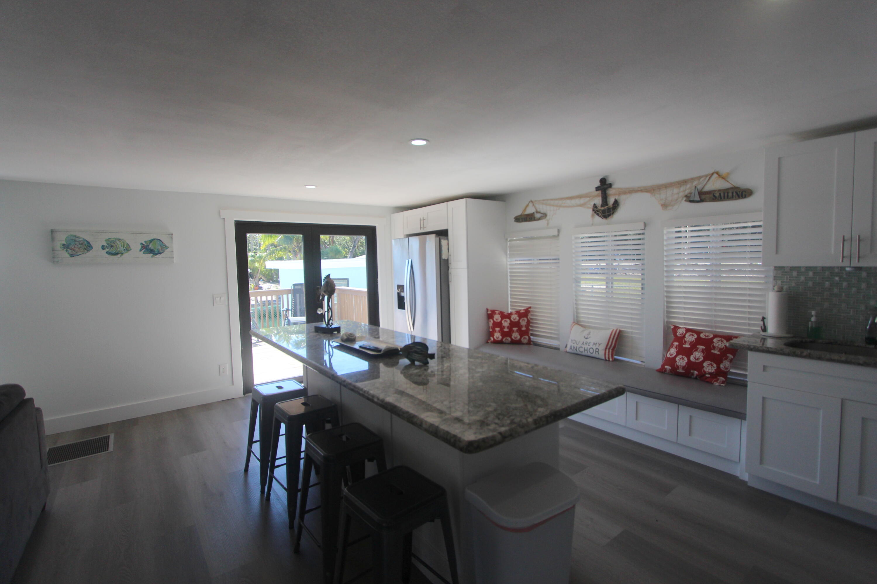 211 Lance Lane Key Largo, FL 33037 - Photo 13 of 52 a view of a dining room with furniture and wooden floor