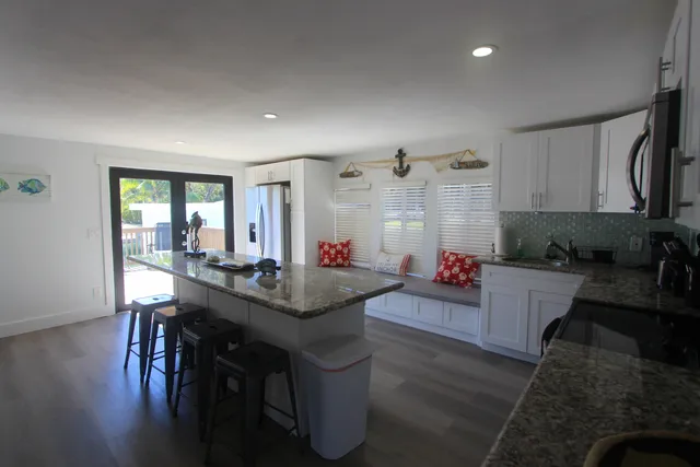 a living room with dining table and wooden floor