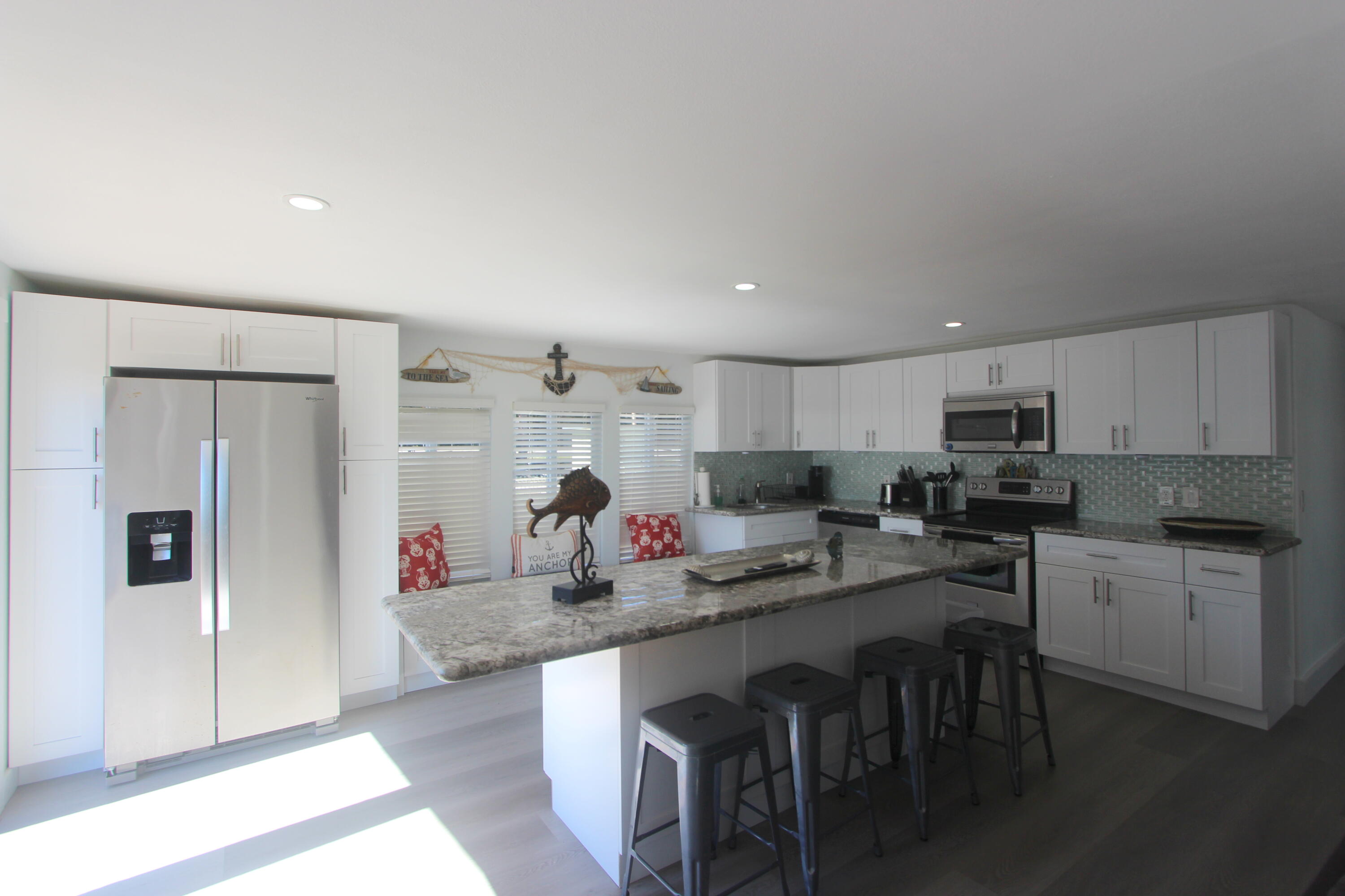 211 Lance Lane Key Largo, FL 33037 - Photo 15 of 52 a kitchen with stainless steel appliances granite countertop a refrigerator and a stove top oven