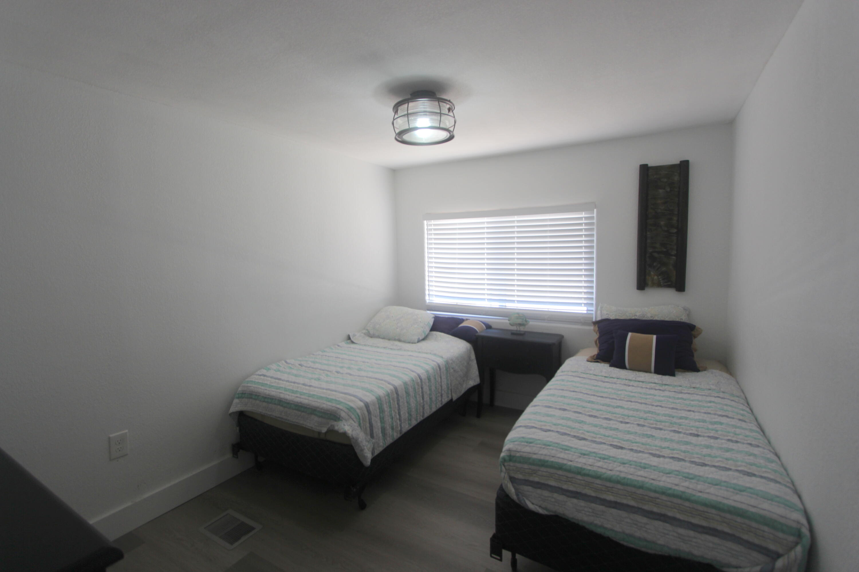211 Lance Lane Key Largo, FL 33037 - Photo 19 of 52 a bedroom with two beds and a window