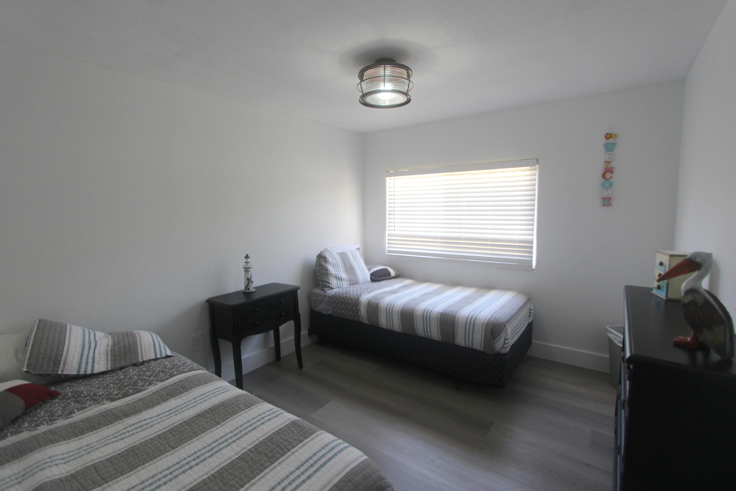 211 Lance Lane Key Largo, FL 33037 - Photo 21 of 52 a bedroom with a bed and a window