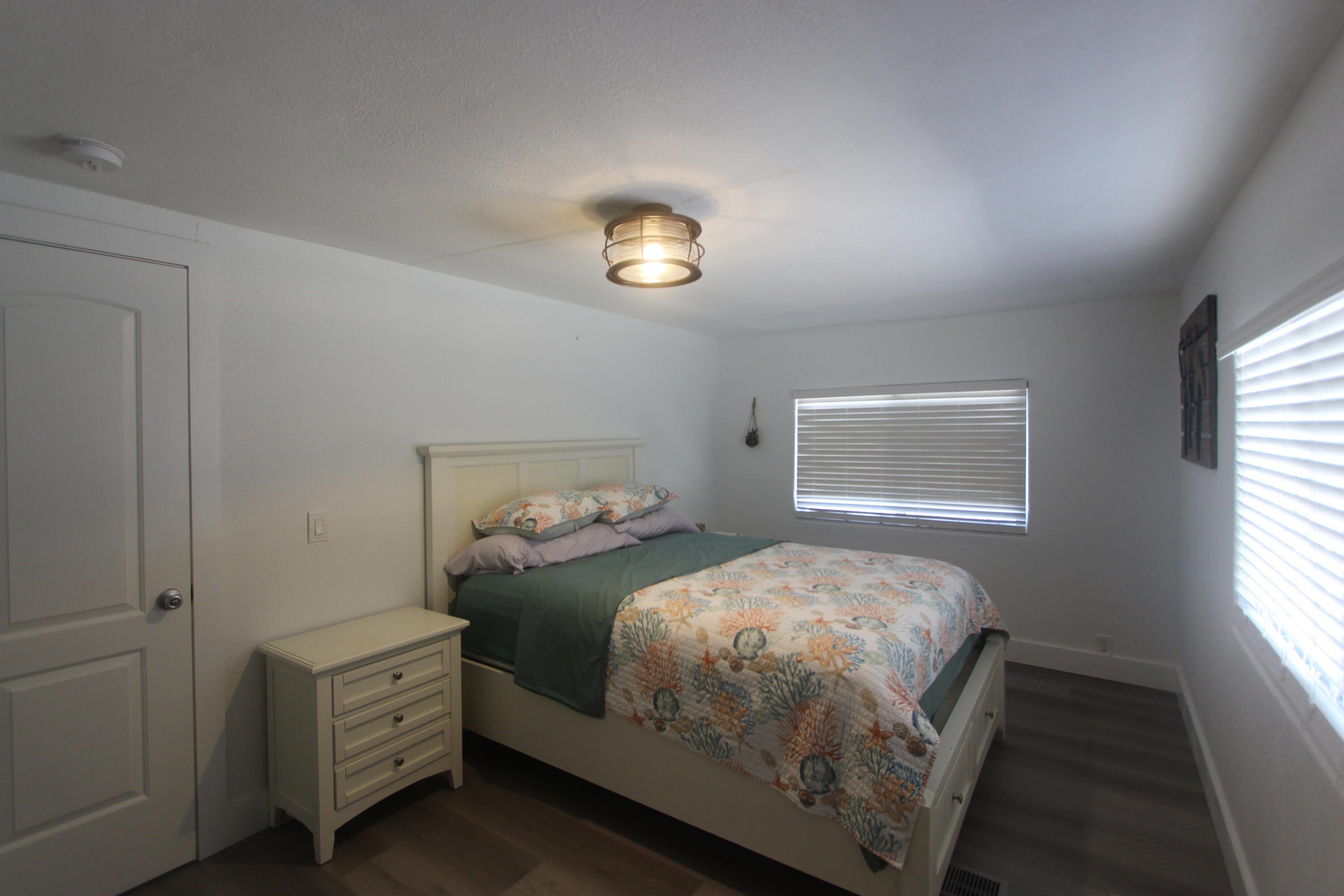 211 Lance Lane Key Largo, FL 33037 - Photo 22 of 52 a bedroom with a bed and a window