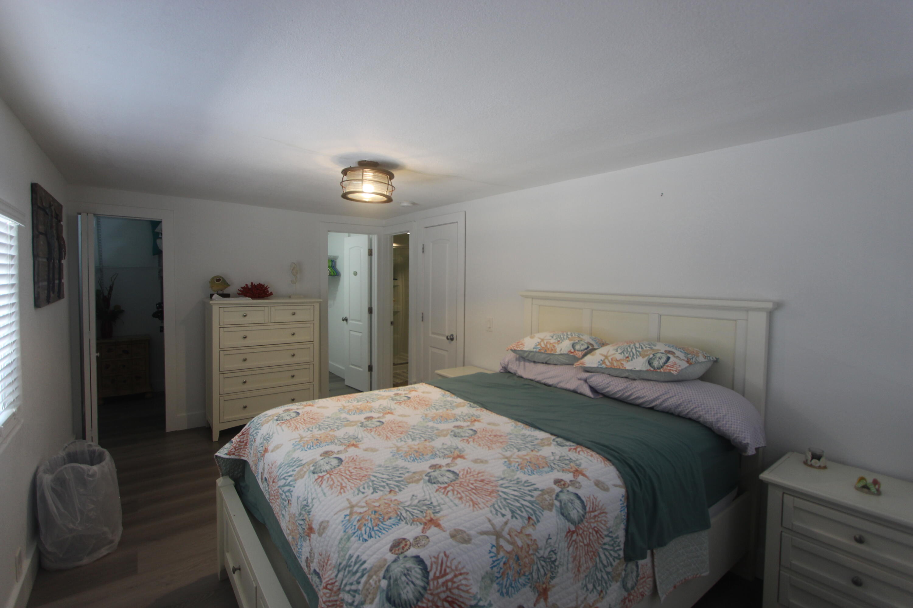 211 Lance Lane Key Largo, FL 33037 - Photo 23 of 52 a bedroom with a bed and a cabinets