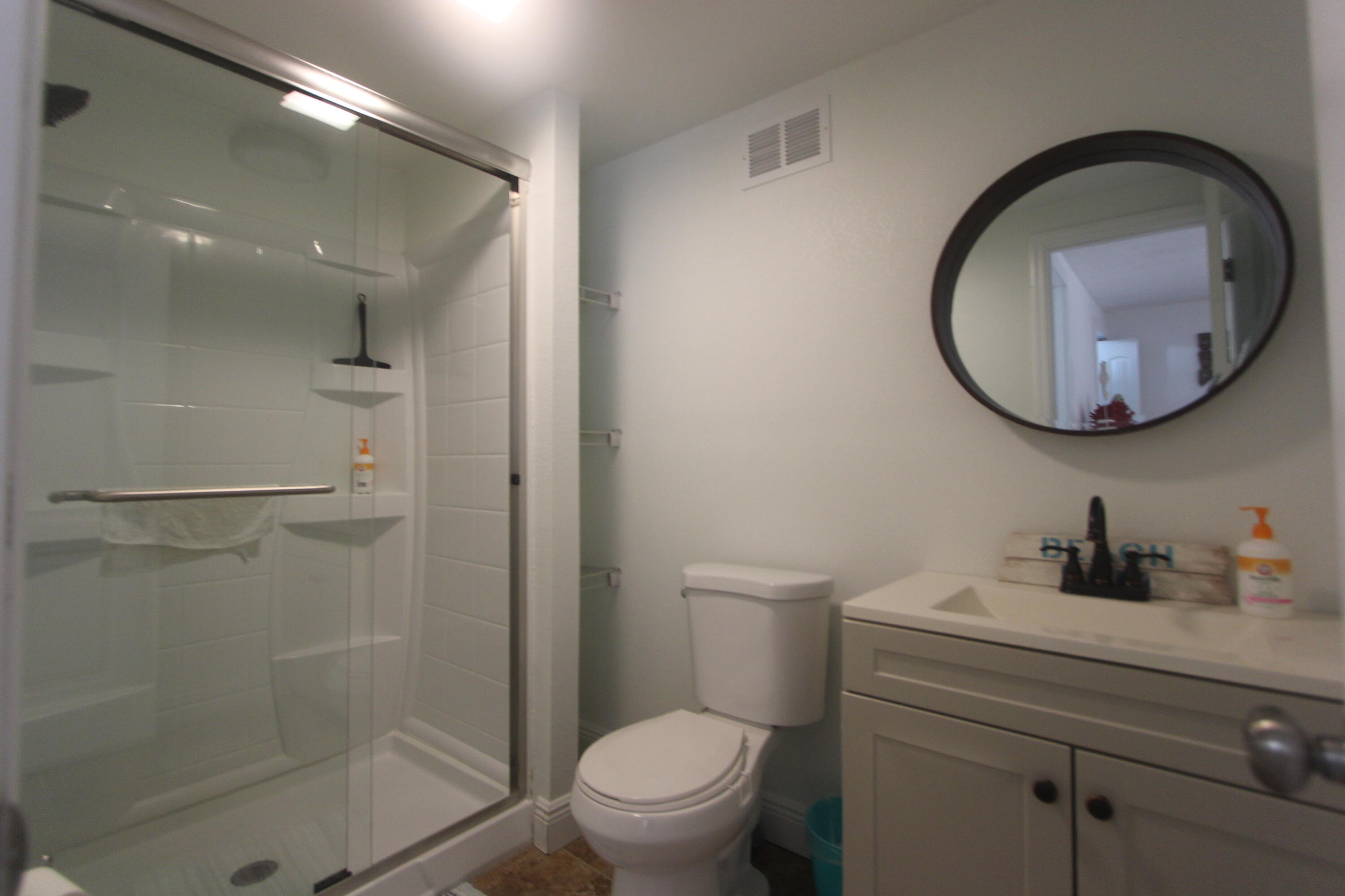 211 Lance Lane Key Largo, FL 33037 - Photo 25 of 52 a bathroom with a toilet sink vanity and mirror