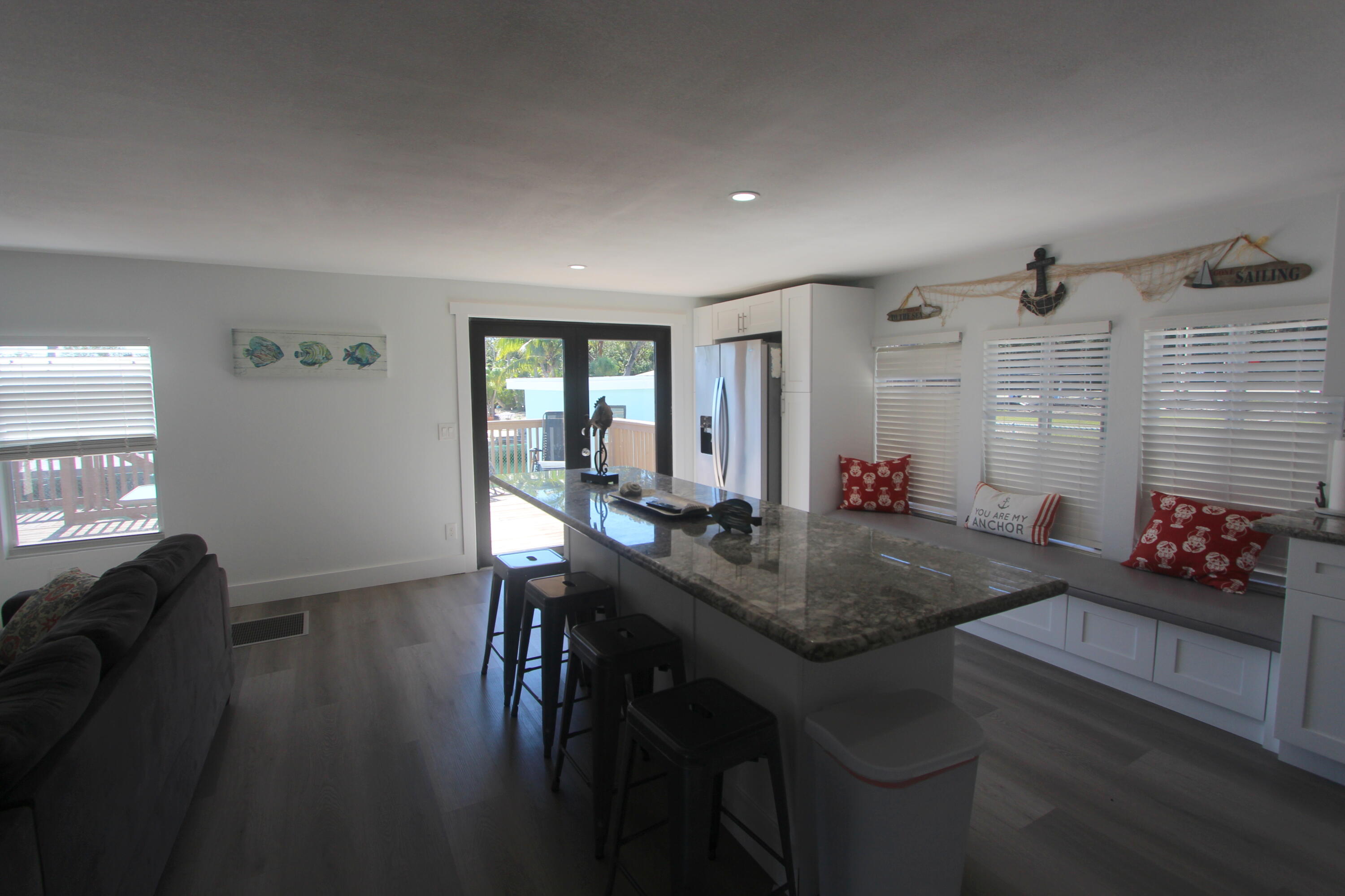 211 Lance Lane Key Largo, FL 33037 - Photo 7 of 52 a view of a dining room with furniture and wooden floor