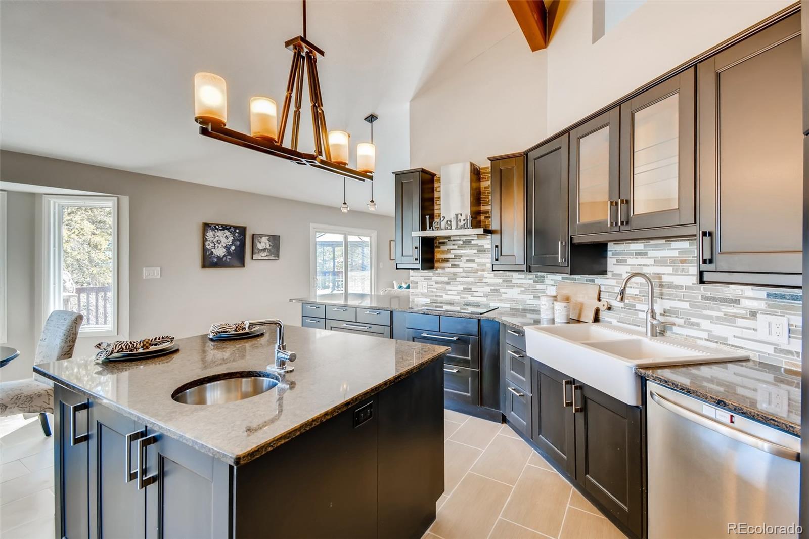 27732 Squaw Pass Road Evergreen, CO 80439 - Photo 12 of 38 a kitchen with stainless steel appliances granite countertop a sink a stove and a refrigerator