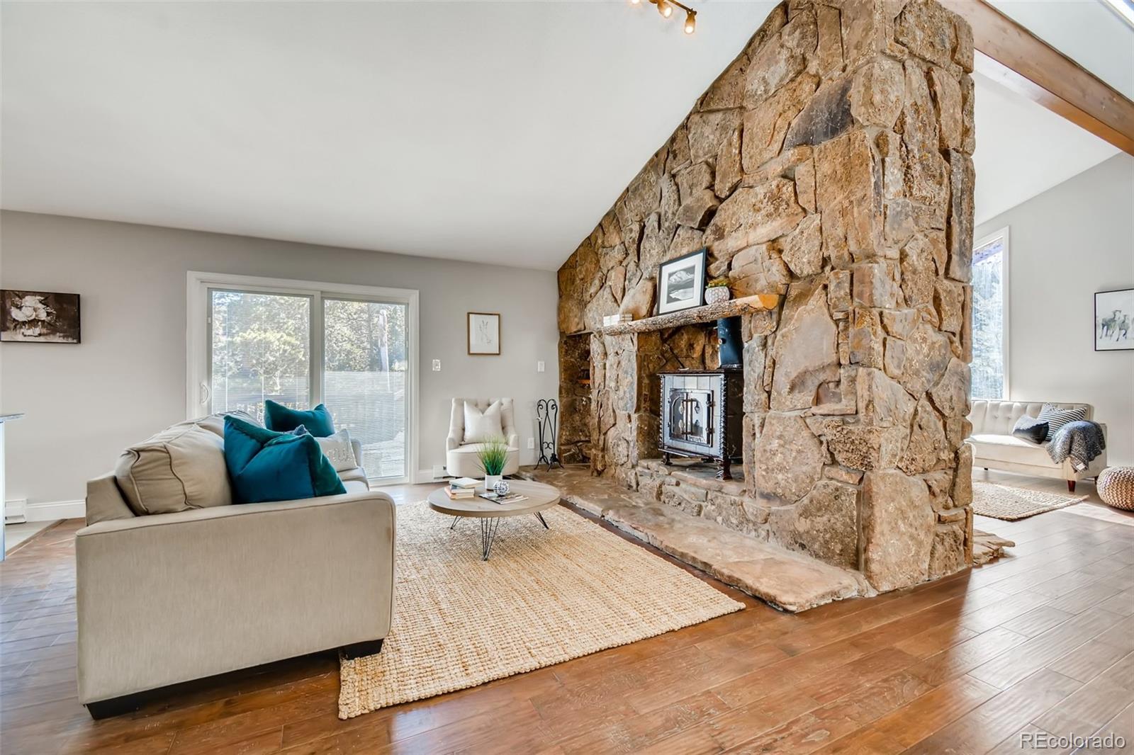 27732 Squaw Pass Road Evergreen, CO 80439 - Photo 14 of 38 a living room with furniture and wooden floor