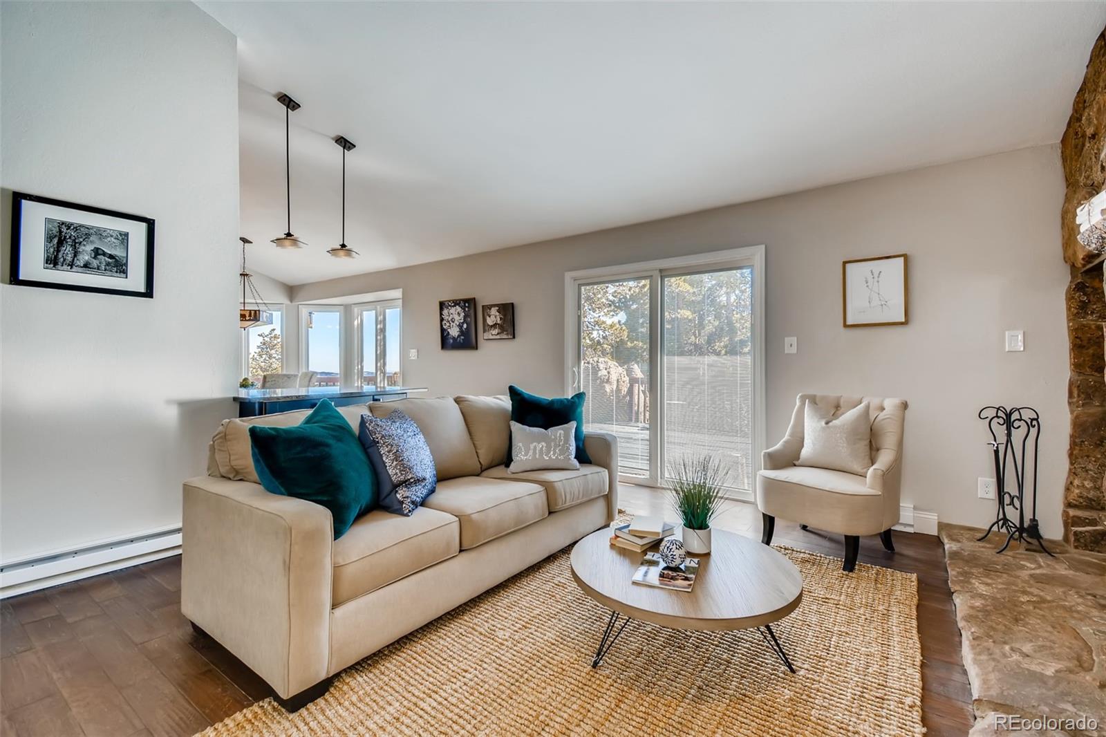 27732 Squaw Pass Road Evergreen, CO 80439 - Photo 15 of 38 a living room with furniture and a wooden floor