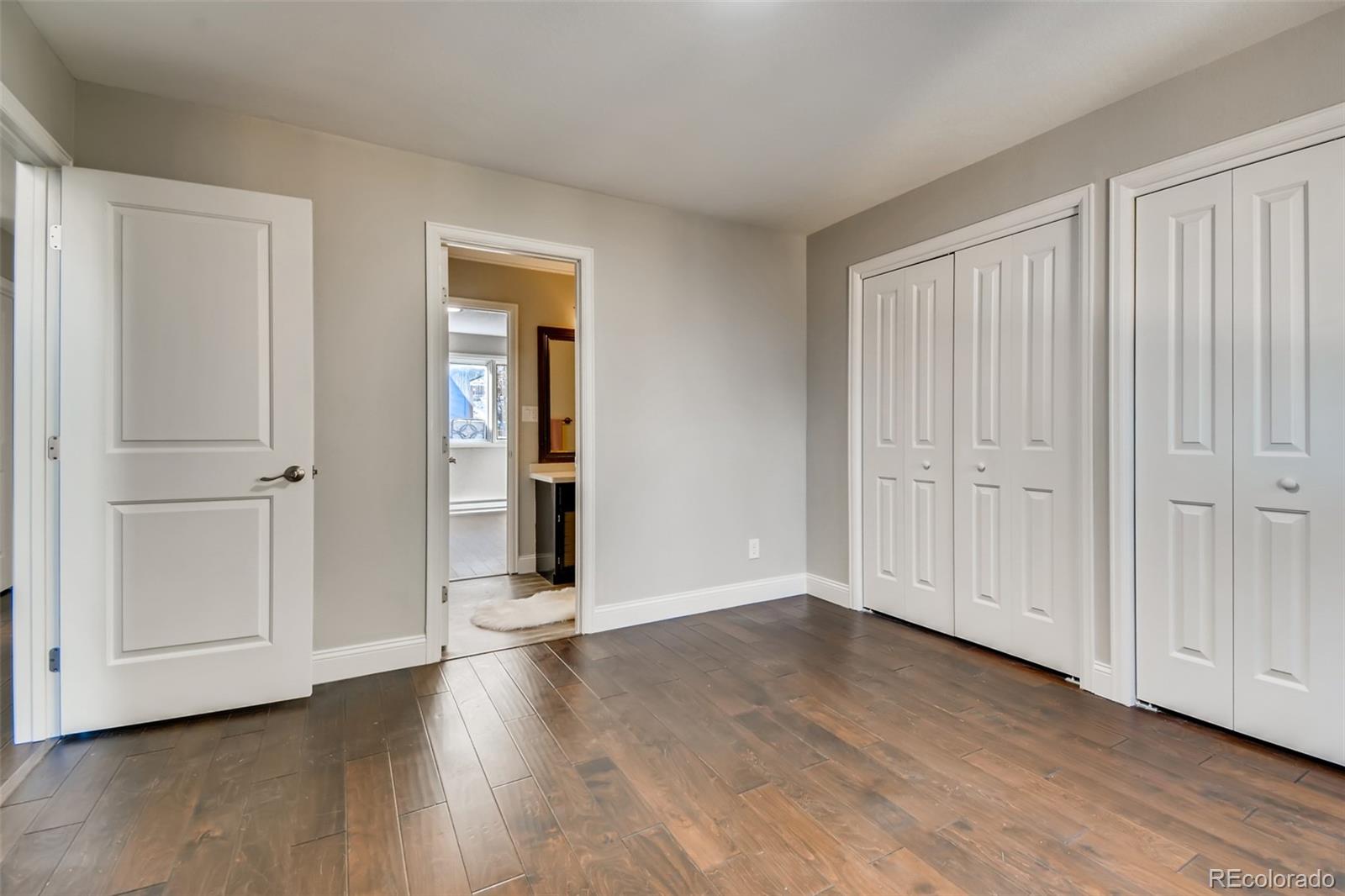 27732 Squaw Pass Road Evergreen, CO 80439 - Photo 18 of 38 a view of an empty room with wooden floor