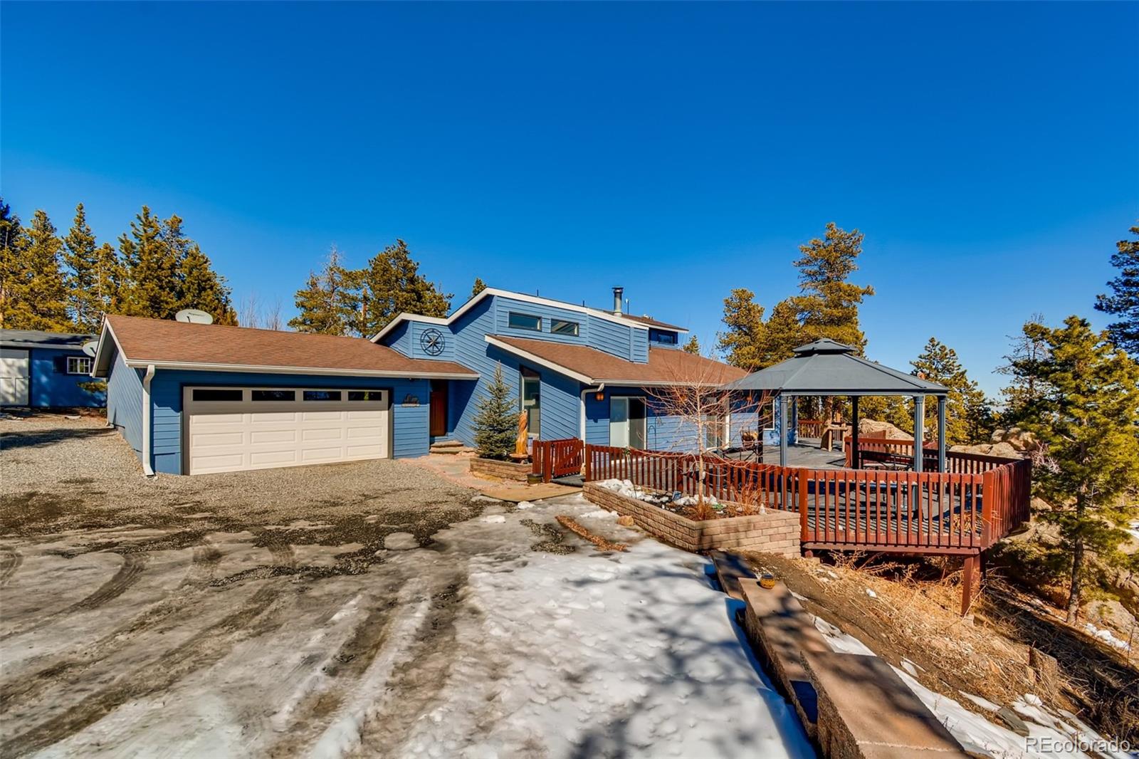 27732 Squaw Pass Road Evergreen, CO 80439 - Photo 2 of 38 a front view of a house with a yard