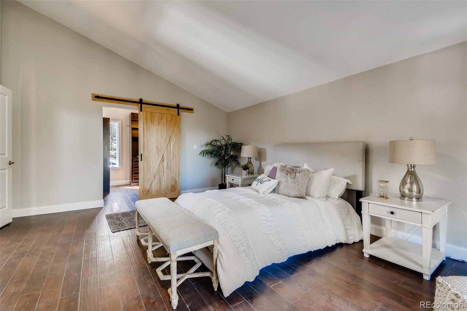 27732 Squaw Pass Road Evergreen, CO 80439 - Photo 23 of 38 a bedroom with a bed and wooden floor