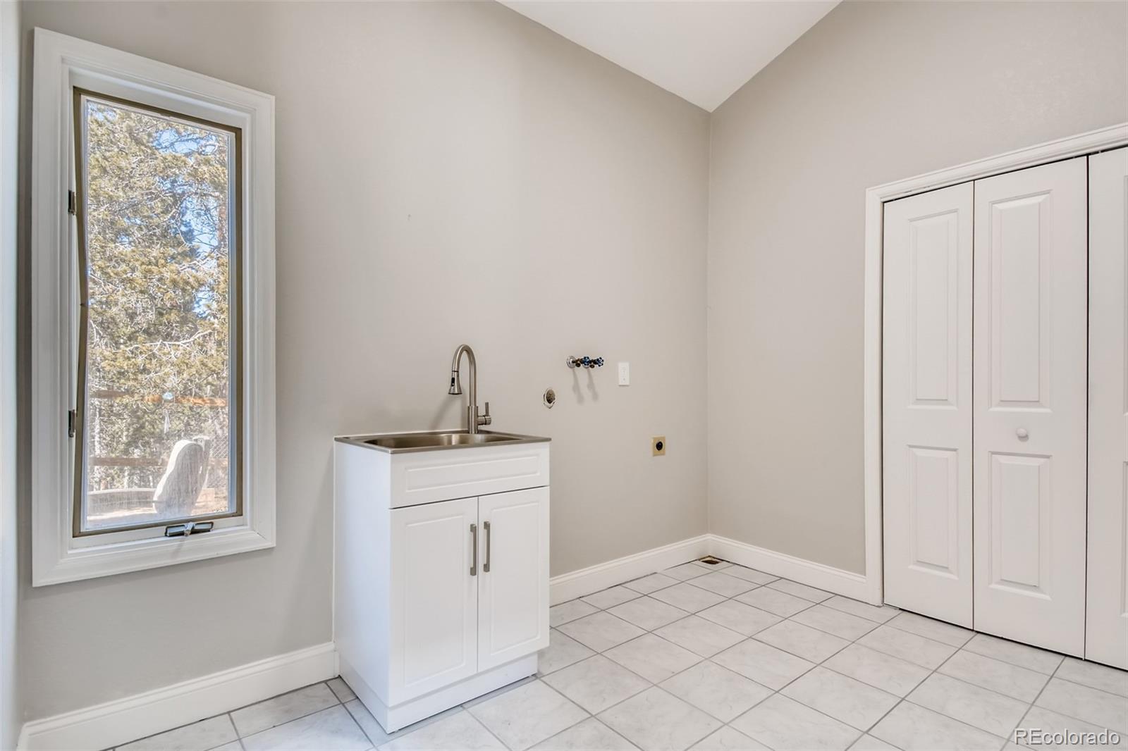 27732 Squaw Pass Road Evergreen, CO 80439 - Photo 28 of 38 a view of a kitchen with white cabinets