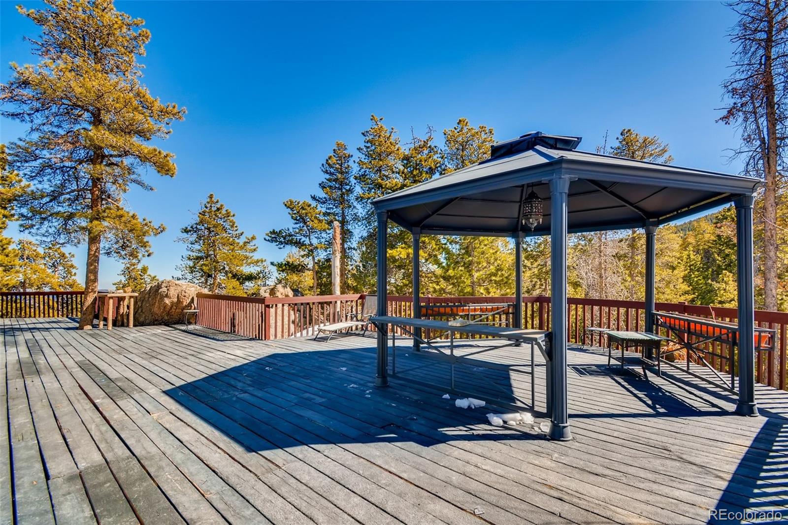 27732 Squaw Pass Road Evergreen, CO 80439 - Photo 30 of 38 a view of a roof deck with wooden floor