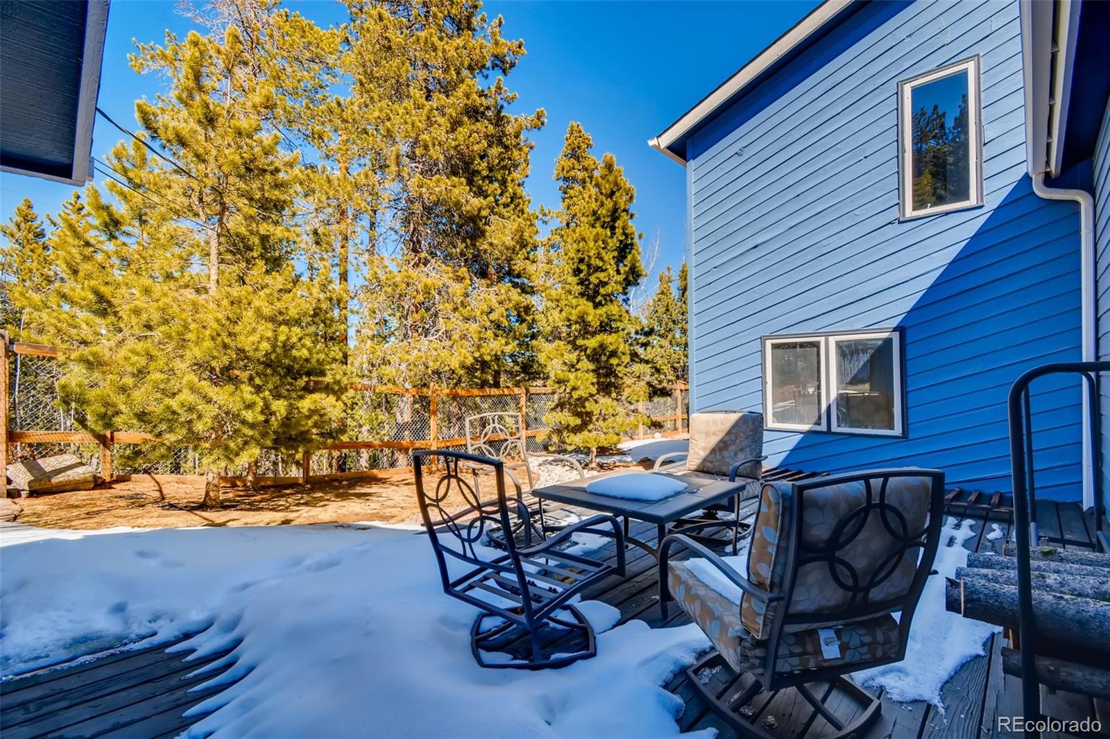 27732 Squaw Pass Road Evergreen, CO 80439 - Photo 34 of 38 a view of a backyard with table and chairs and potted plants
