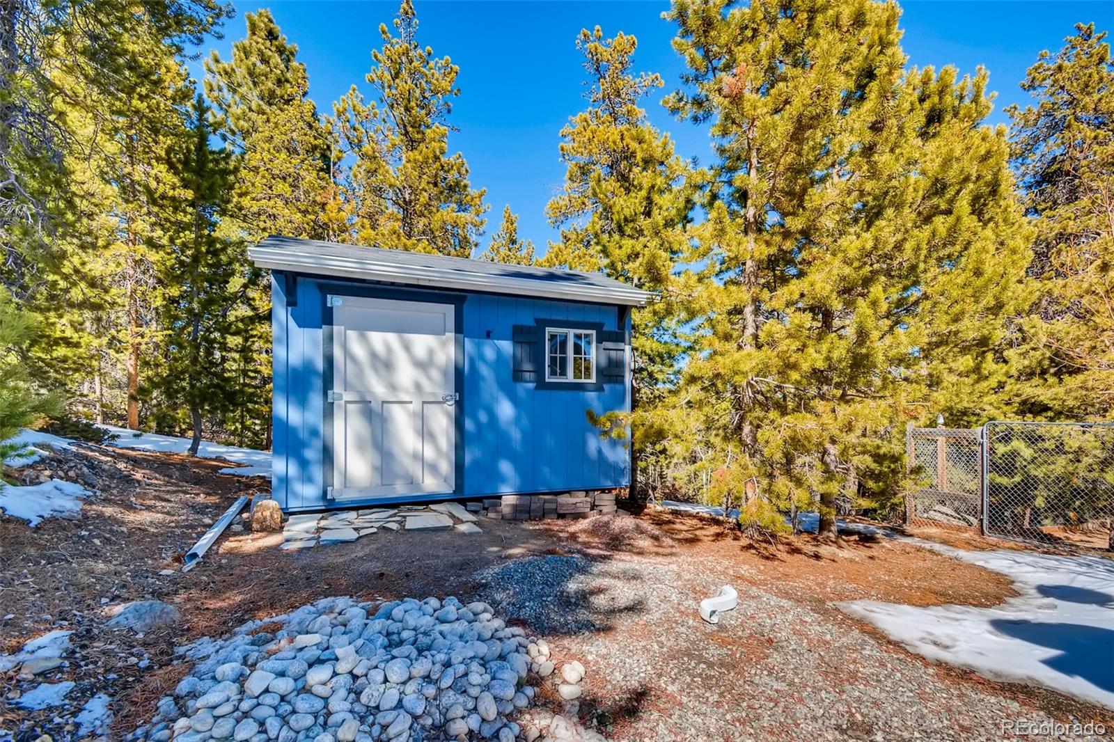 27732 Squaw Pass Road Evergreen, CO 80439 - Photo 36 of 38 a front view of a house with a yard