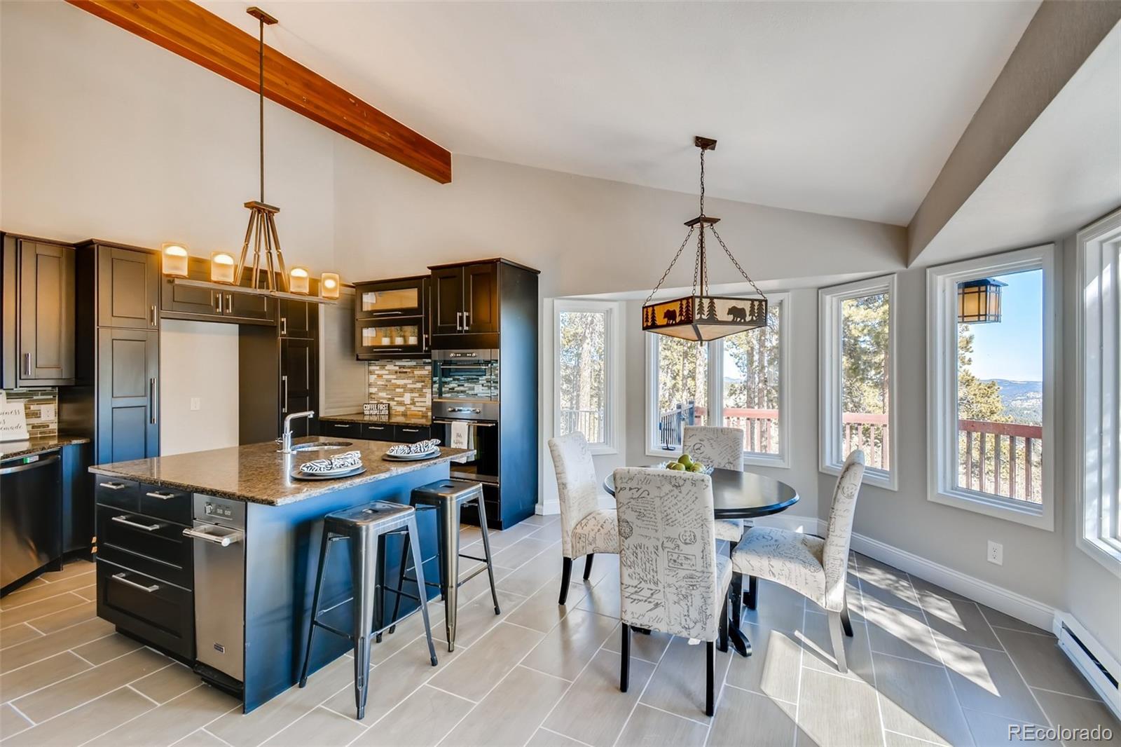 27732 Squaw Pass Road Evergreen, CO 80439 - Photo 9 of 38 a kitchen with stainless steel appliances granite countertop a stove and refrigerator