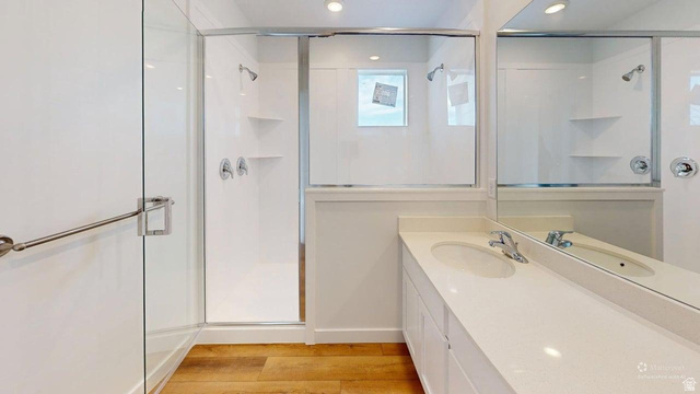 783 Pheasantbrook Drive, Unit 2A Centerville, UT 84014 - Photo 16 of 41 Bathroom featuring a frameless glass-enclosed shower with chrome fixtures and integrated shelving