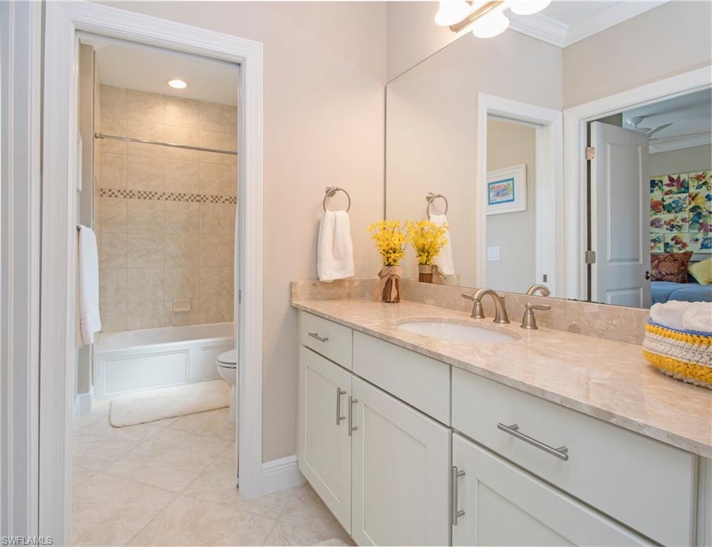 4423 Raffia Palm Circle Naples, FL 34119 - Photo 18 of 25 Large guest bath with tub/shower combo, marble and diaganol tile.