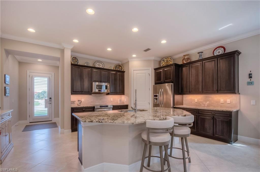 4423 Raffia Palm Circle Naples, FL 34119 - Photo 2 of 25 Under cabinet lighting & stainless steel appliances.