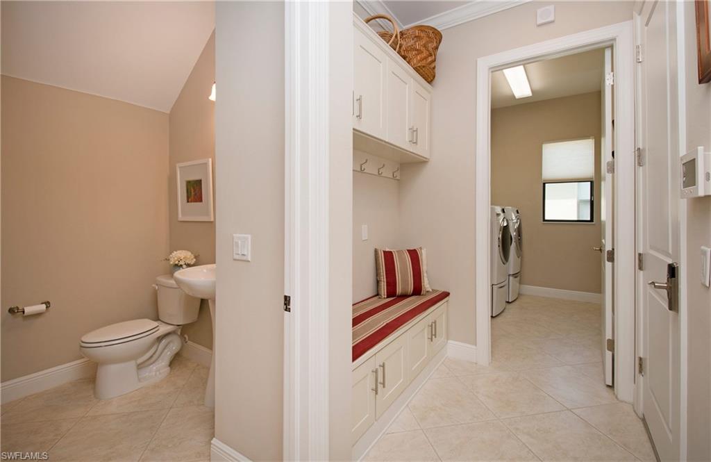 4423 Raffia Palm Circle Naples, FL 34119 - Photo 21 of 25 Garage entry built-in with storage & seating. Laundry room w/sink.