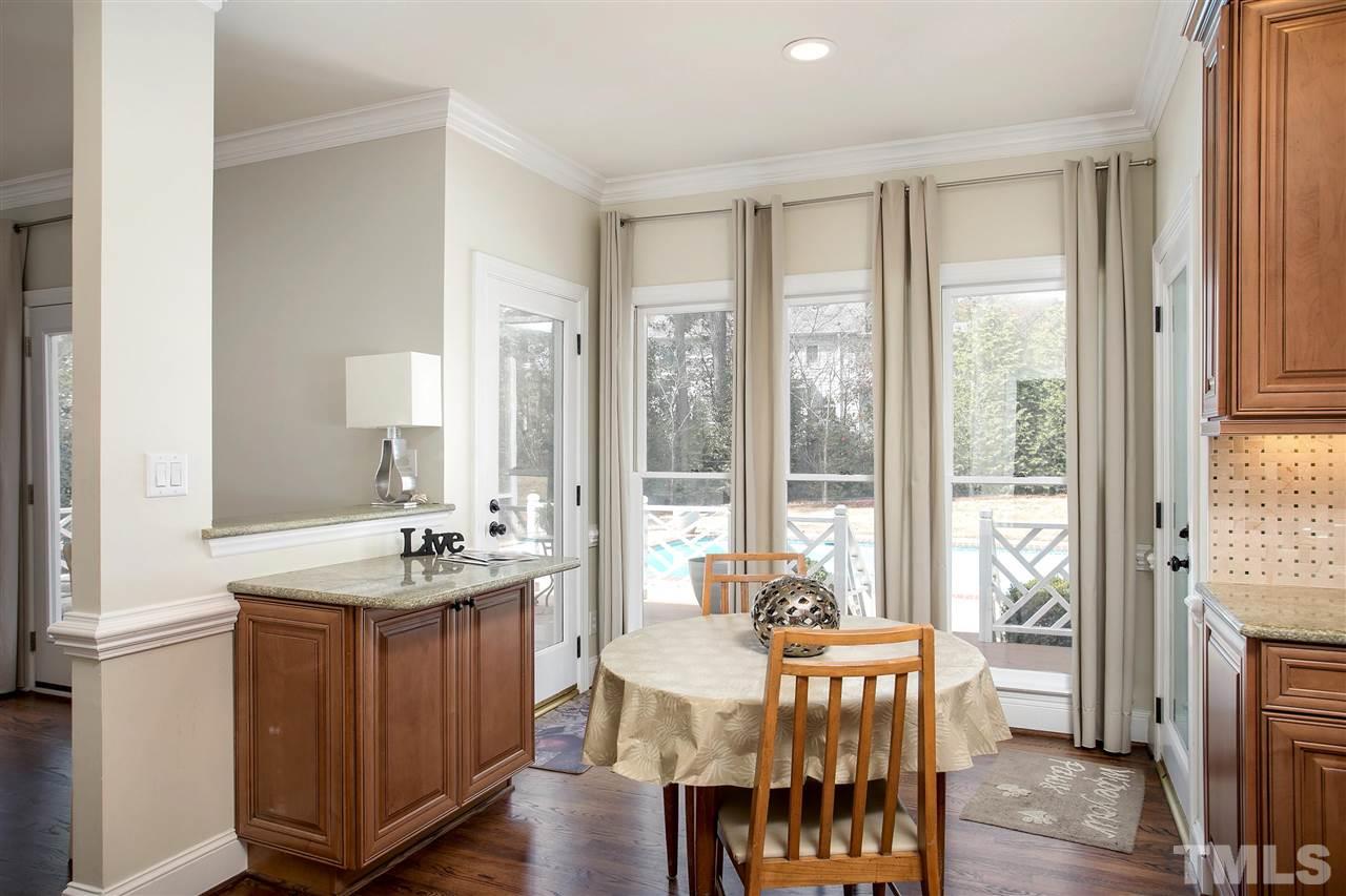 7102 Spring Ridge Road Cary, NC 27518 - Photo 11 of 25 SIT AND HAVE A BITE WHILE YOU LOOK OUT INTO YOUR PRIVATE POOL AND LUSH BACK YARD!