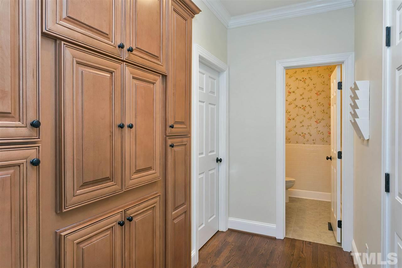 7102 Spring Ridge Road Cary, NC 27518 - Photo 12 of 25 THIS IS SO UNIQUE YOU WILL LOVE IT...LAUNDRY TUCKED IN THIS CUSTOM CABINET! JUST OFF THE GARAGE AND RIGHT BY A HUGE PANTRY SO BECOMES A NATURAL "DROP" AREA.