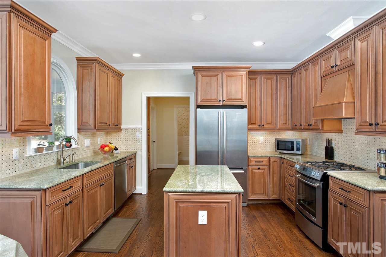 7102 Spring Ridge Road Cary, NC 27518 - Photo 8 of 25 WONDERFUL COOK'S KITCHEN WITH STAINLESS STEEL APPLIANCES, NEWER CABINETS, ISLAND AND LOVELY GRANITE COUNTER TOPS!