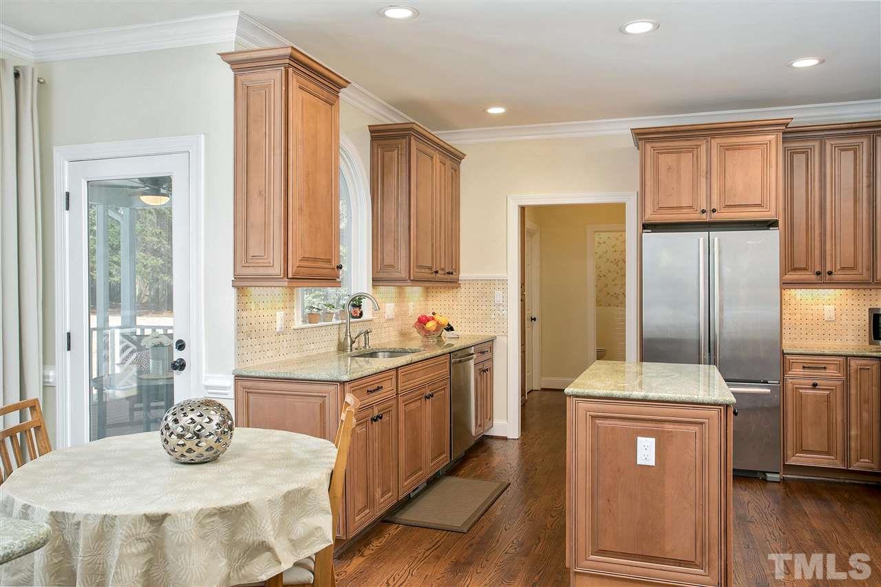7102 Spring Ridge Road Cary, NC 27518 - Photo 10 of 25 LOTS OF SPACE IN THIS KITCHEN - BREAKFAST AREA SHOWN HERE WITH A PEAK INTO THE SCREENED PORCH!
