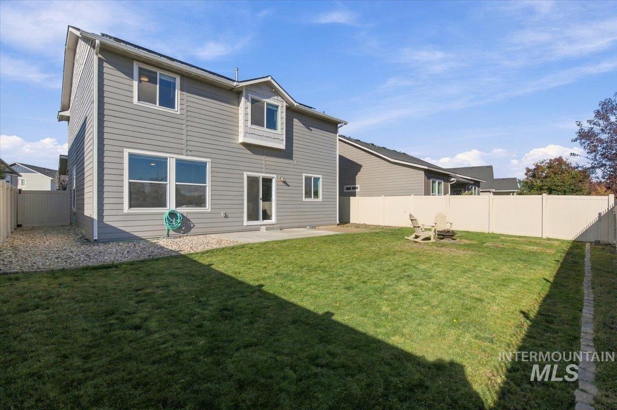 124 South Sunset Point Way Meridian, ID 83642 - Photo 24 of 24 Expansive backyard featuring a privacy fence, concrete patio, and siding exterior