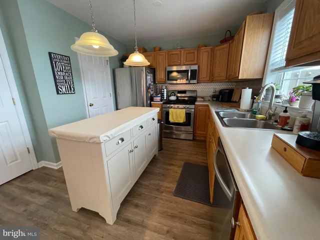 a kitchen with white cabinets and sink
