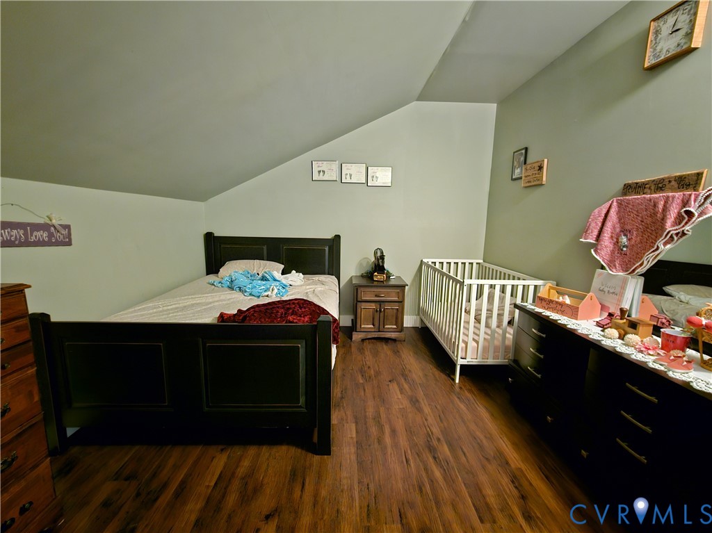 3814 South Constitution Route Dillwyn, VA 23936 - Photo 16 of 42 a living room with a bed wooden floor and furniture