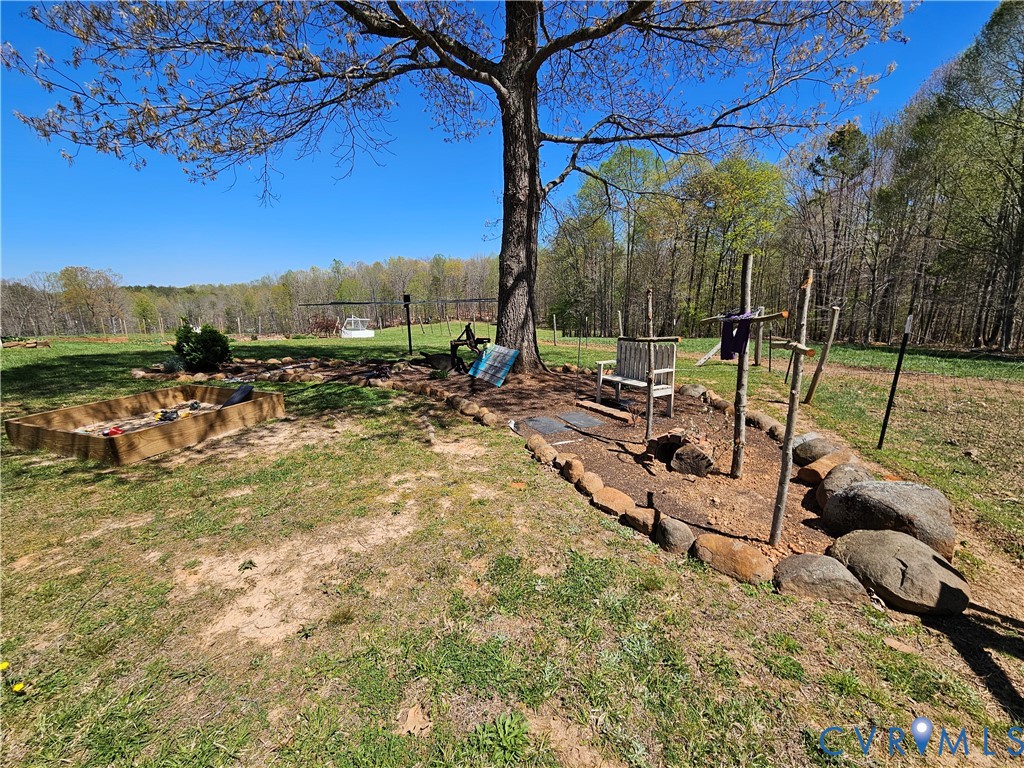 3814 South Constitution Route Dillwyn, VA 23936 - Photo 41 of 49 a view of a backyard with couches under an umbrella