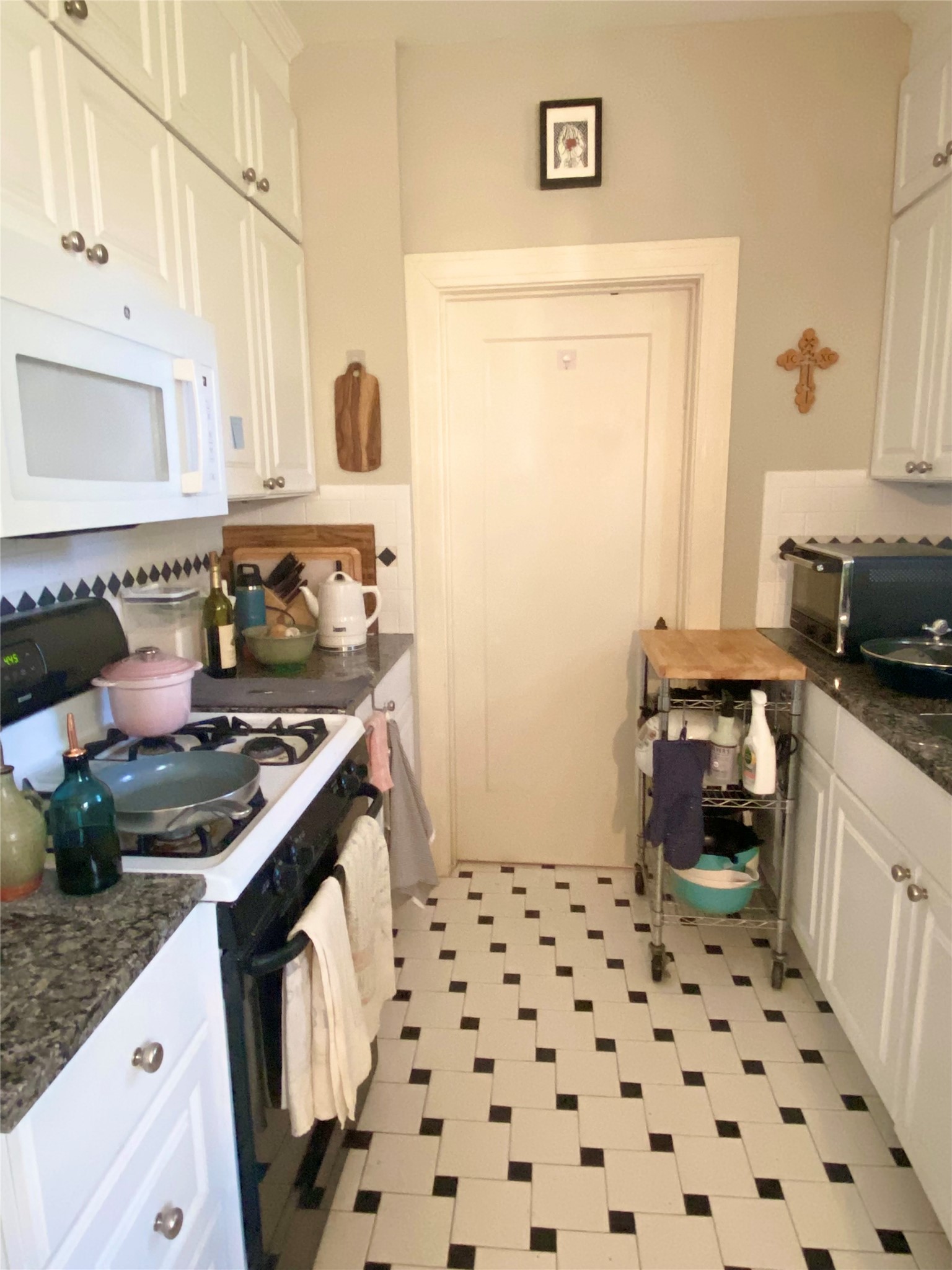 3106 Walling Drive Austin, TX 78705 - Photo 12 of 30 a kitchen with a stove and a sink