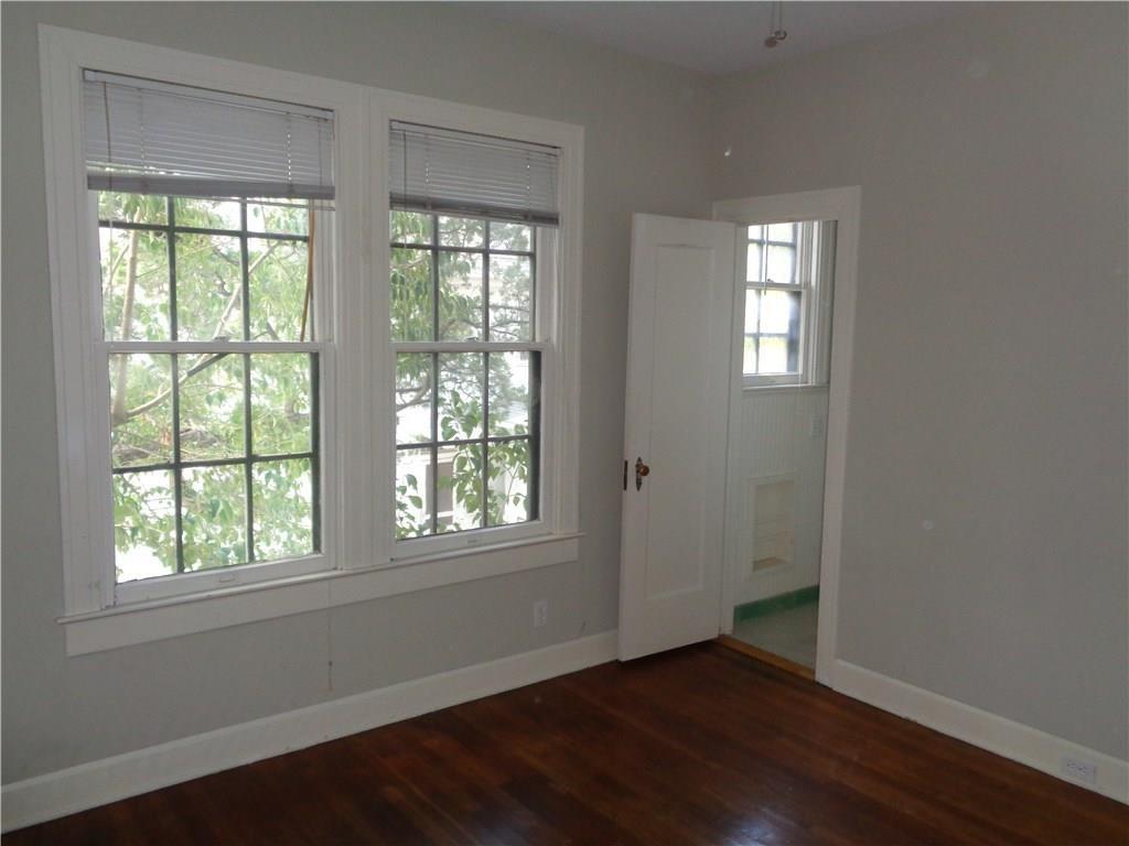 3106 Walling Drive Austin, TX 78705 - Photo 17 of 30 a view of an empty room with wooden floor and a window