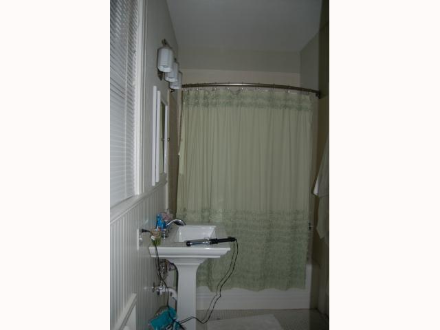 3106 Walling Drive Austin, TX 78705 - Photo 26 of 30 a bathroom with a sink a mirror and a shower