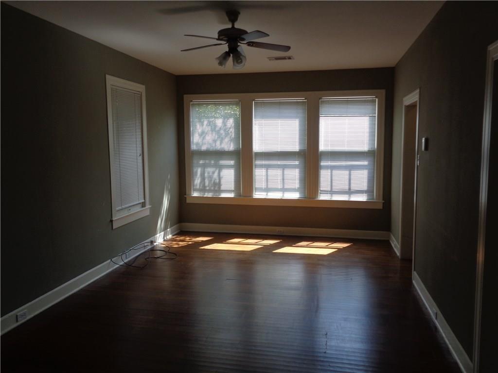 3106 Walling Drive Austin, TX 78705 - Photo 3 of 30 a view of an empty room with wooden floor and a window