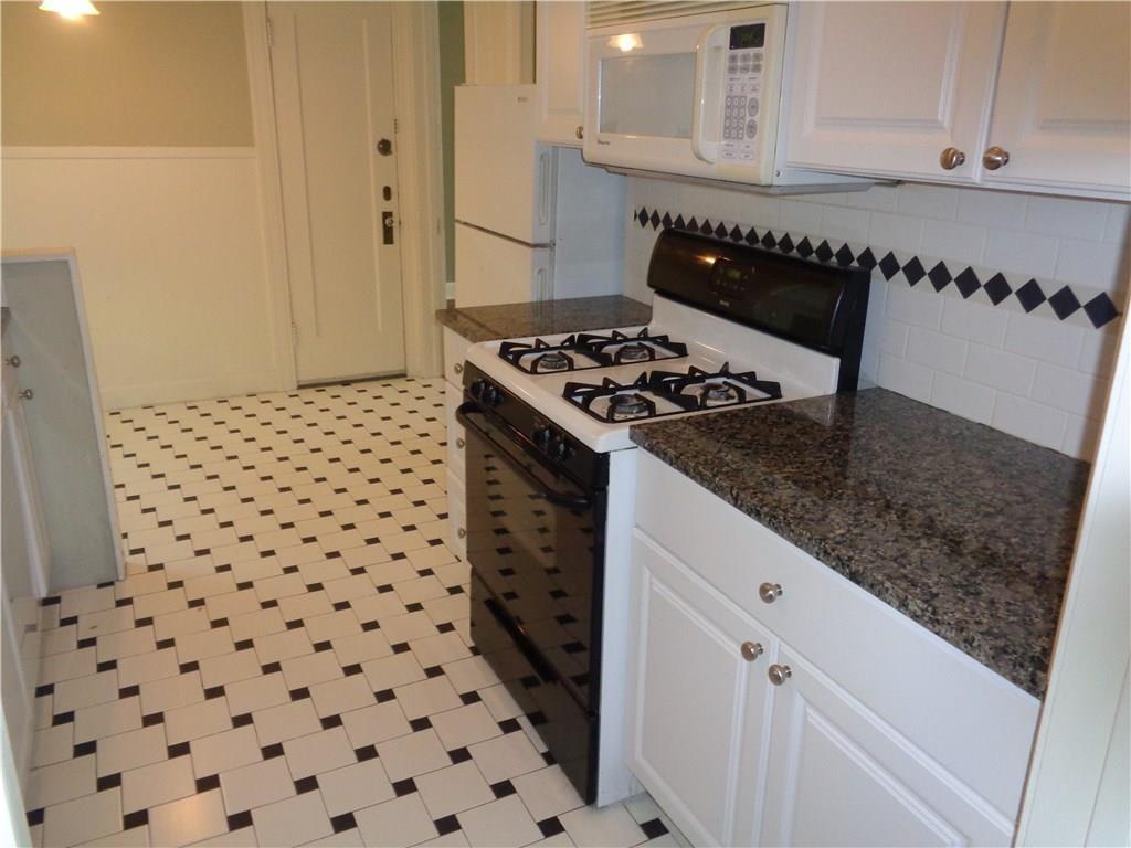 3106 Walling Drive Austin, TX 78705 - Photo 8 of 30 a kitchen with a stove a sink and a refrigerator