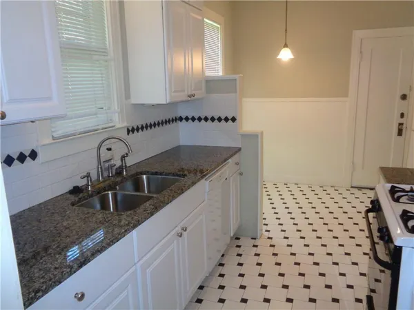 a kitchen with a sink and cabinets