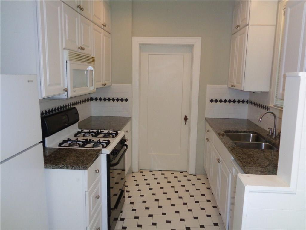 3106 Walling Drive Austin, TX 78705 - Photo 10 of 30 a kitchen with granite countertop a stove and a sink