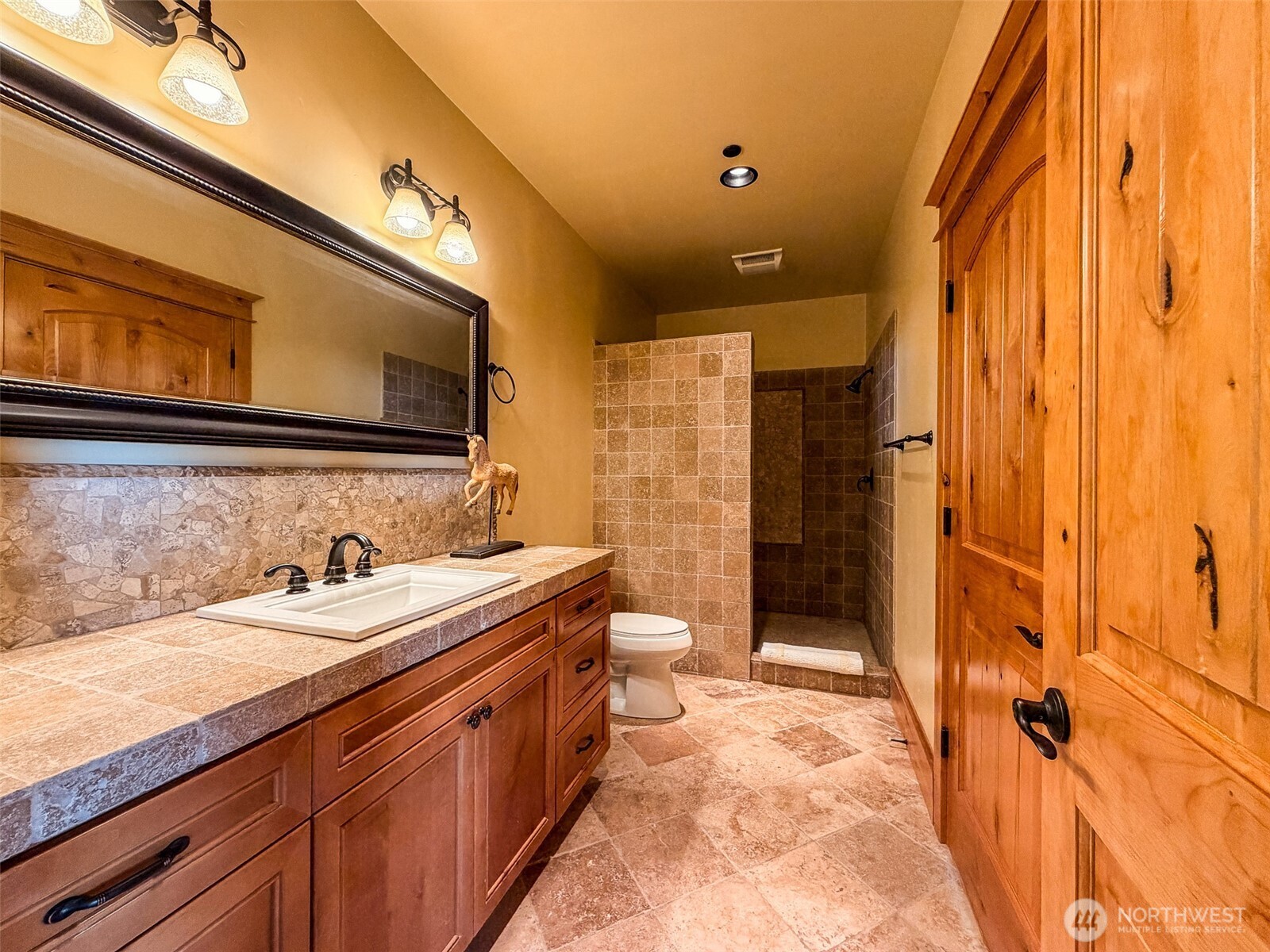 726 Pine Ridge Drive Orcas Island, WA 98280 - Photo 20 of 40 a bathroom with a granite countertop sink a toilet and shower