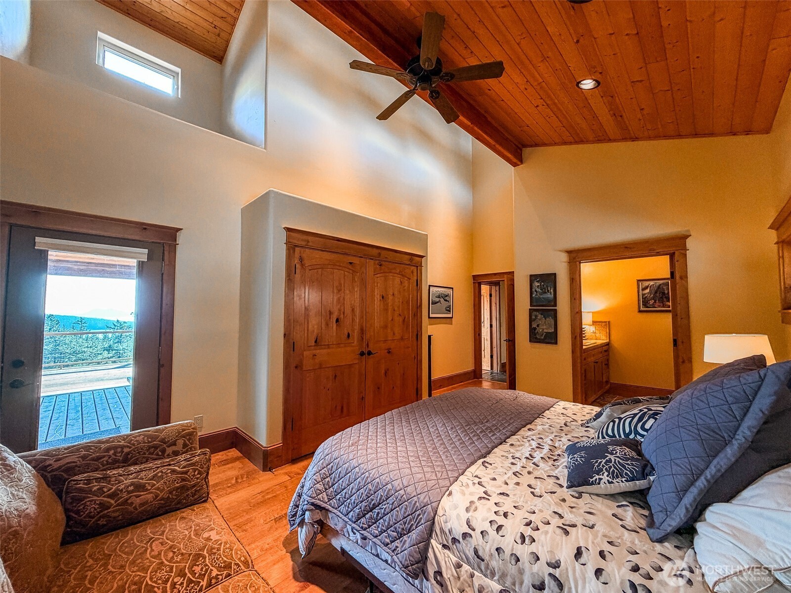 726 Pine Ridge Drive Orcas Island, WA 98280 - Photo 26 of 40 a bedroom with a large bed and wooden floor