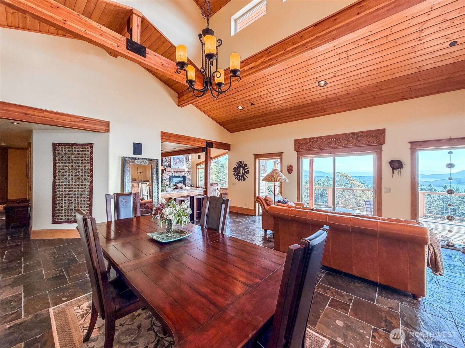 726 Pine Ridge Drive Orcas Island, WA 98280 - Photo 10 of 40 a dining room with furniture a chandelier and wooden floor
