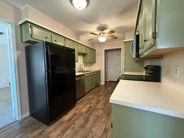 a kitchen with stainless steel appliances a refrigerator and a stove
