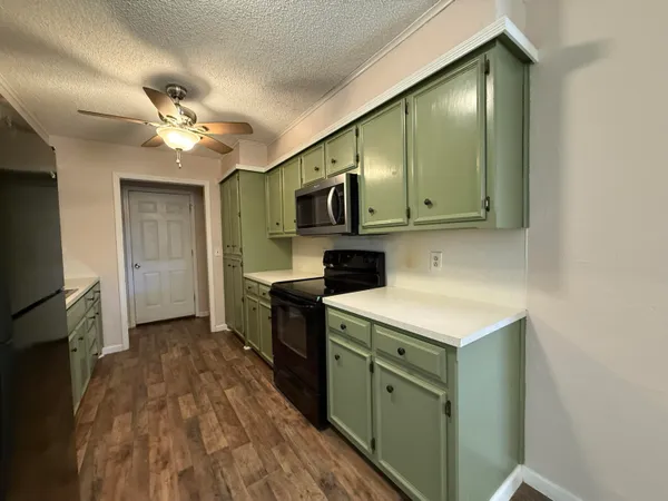 a kitchen with a sink stove and refrigerator