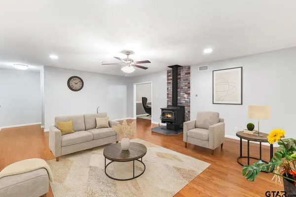 a living room with furniture a rug and a large window