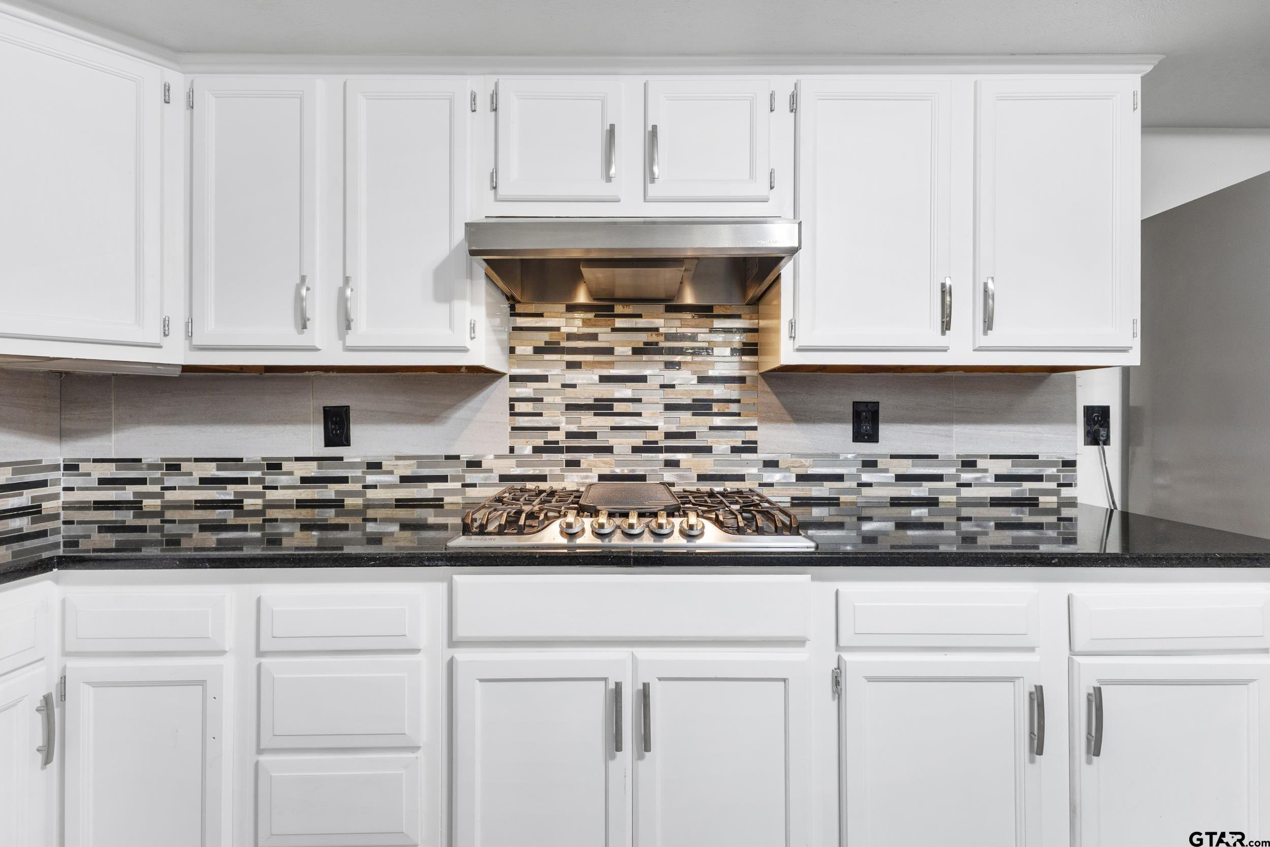 109 King Lyle Road Scroggins, TX 75480 - Photo 13 of 46 a kitchen with white cabinets and stainless steel appliances
