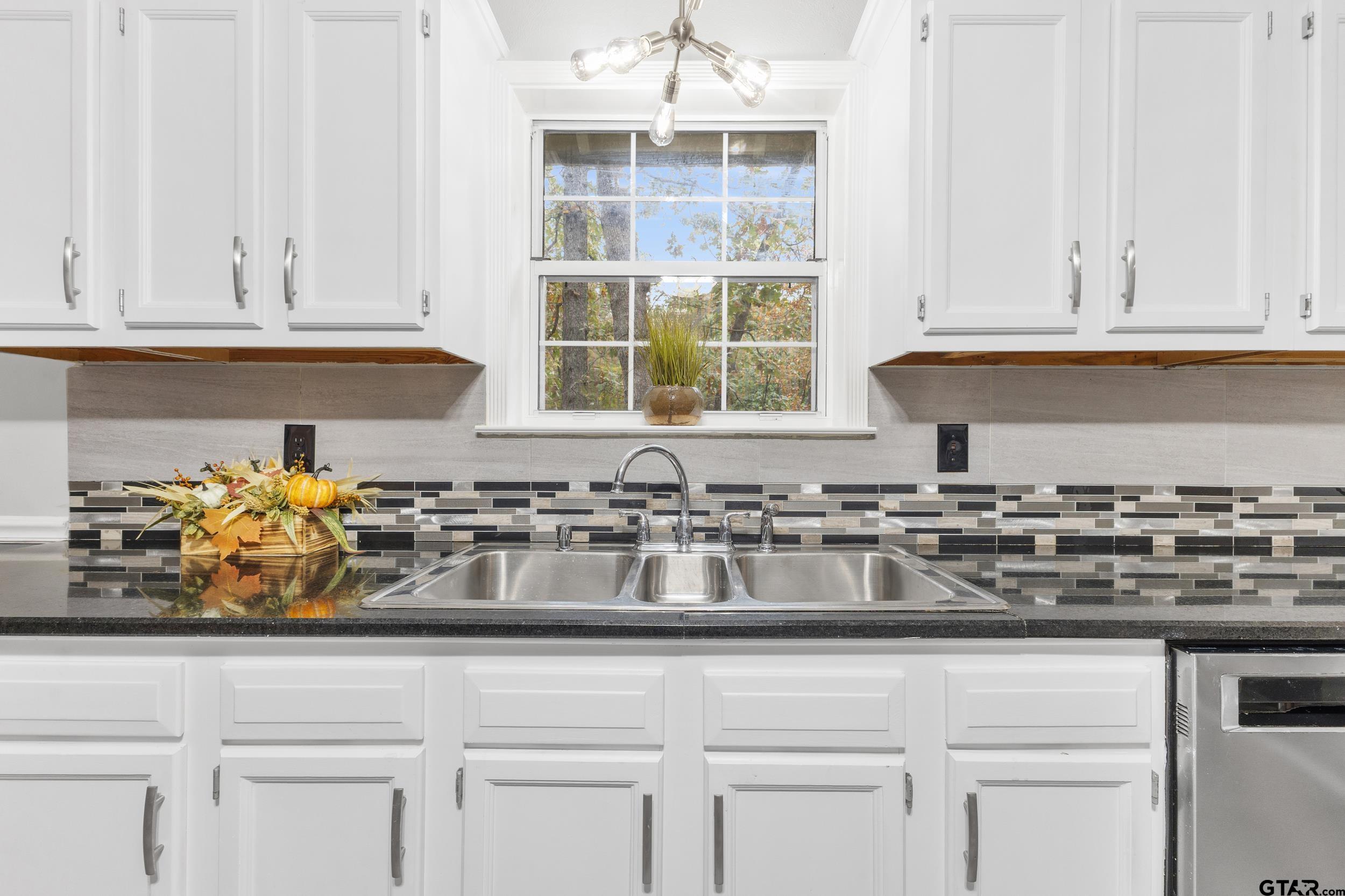 109 King Lyle Road Scroggins, TX 75480 - Photo 14 of 46 a kitchen with stainless steel appliances granite countertop white cabinets and a window
