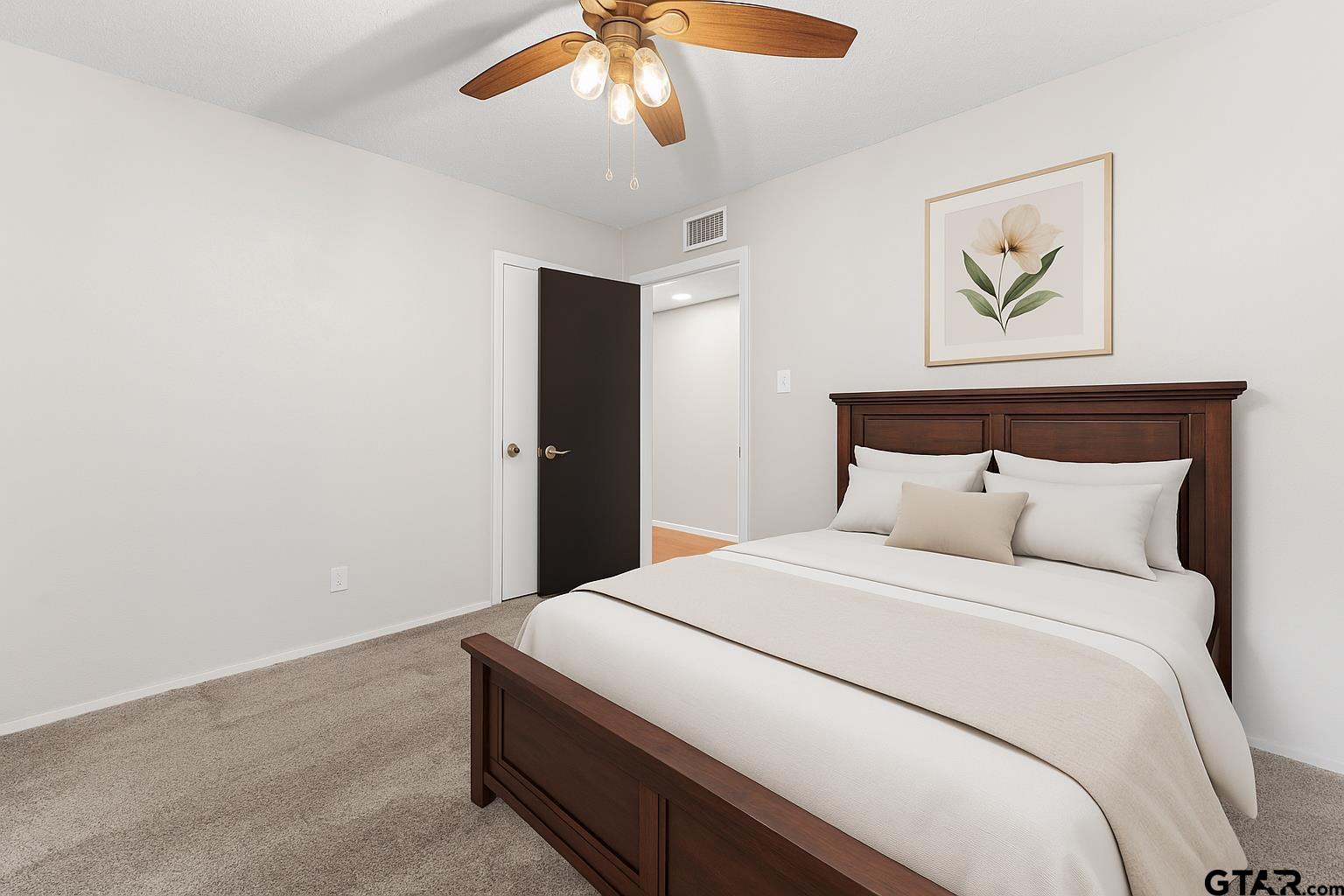 109 King Lyle Road Scroggins, TX 75480 - Photo 19 of 46 a bedroom with a large bed and a chandelier