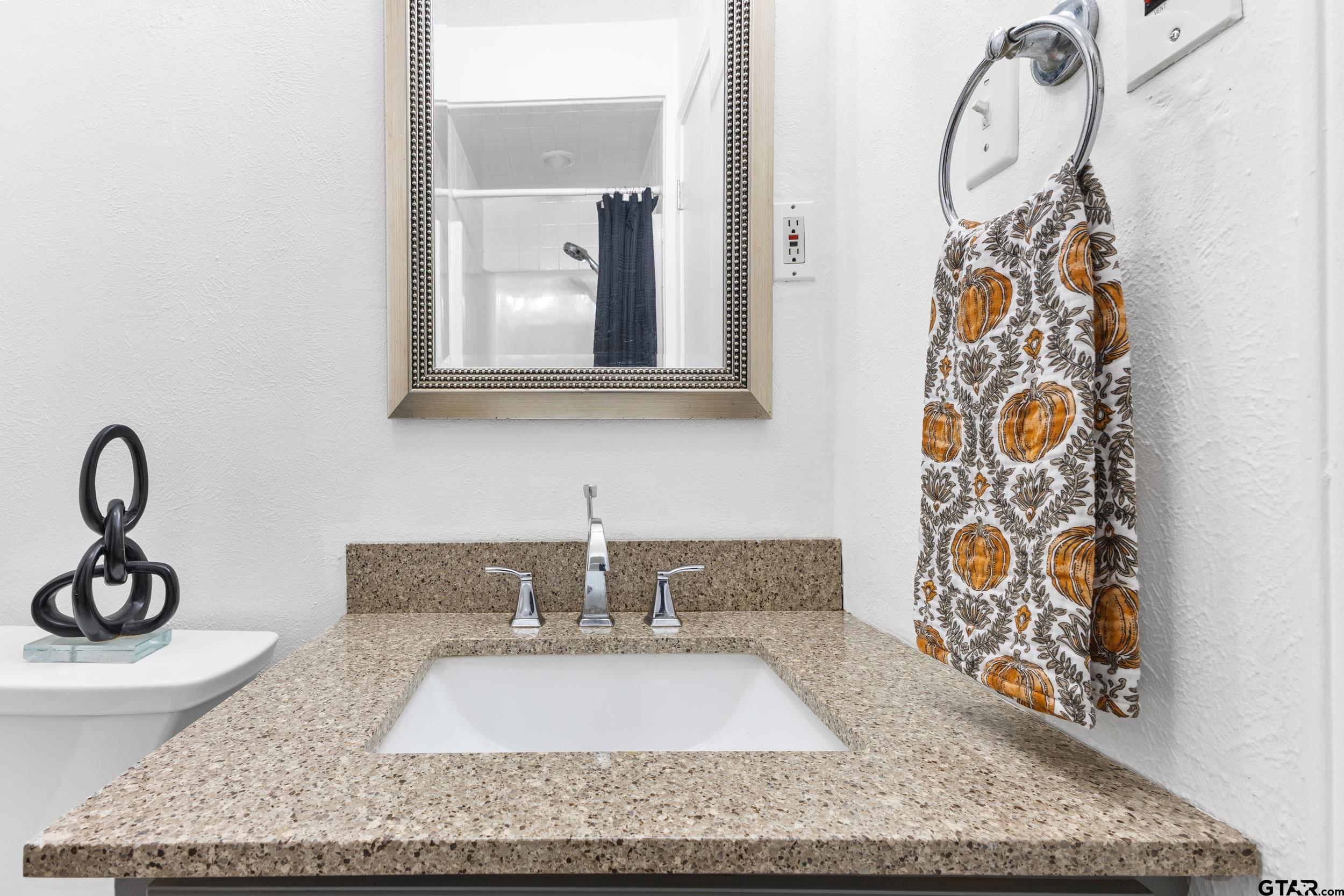 109 King Lyle Road Scroggins, TX 75480 - Photo 23 of 46 a bathroom with a granite countertop sink and a mirror